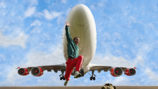 Een danser springt omhoog met een opstijgend vliegtuig in de achtergrond