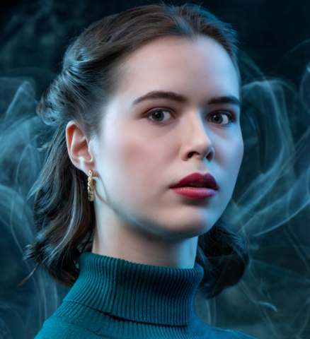 Marthe Ledegang als Agent Cobbet in blauwe coltrui met gevouwen armen in Sherlock Holmes