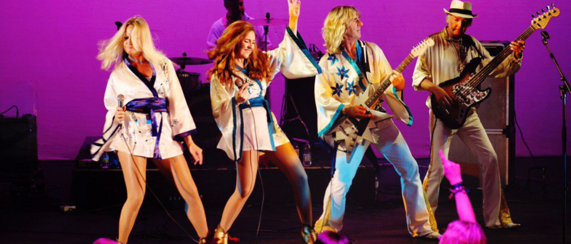 ABBA Gold Europe performers in witte kostuums dansen op paars verlicht podium Hoorn